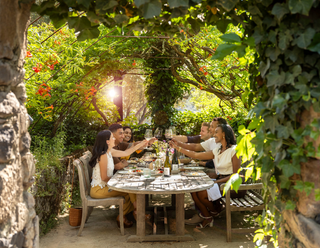 Group of men and women around a table enjoying food and wine at Stags' Leap Winery