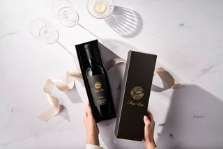 Woman opening one bottle of Stags' Leap wine in a black gift box