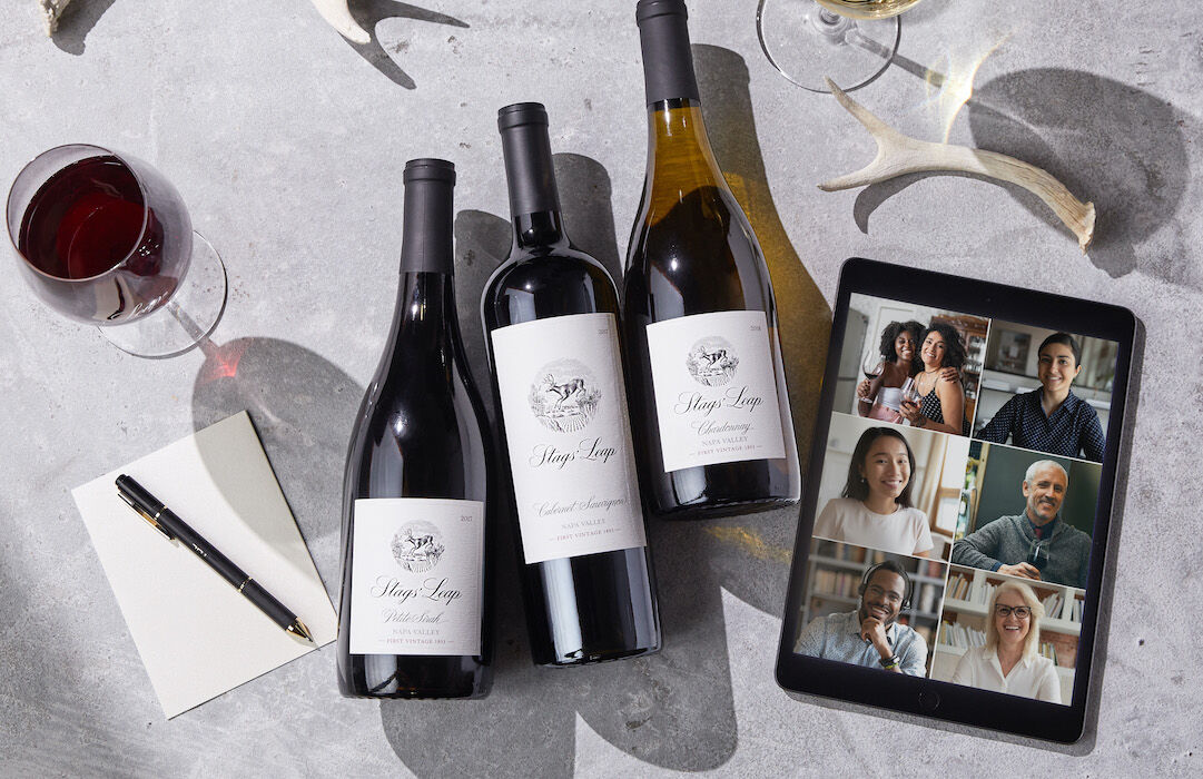 video call on tablet with stags' leap bottles and wine glasses